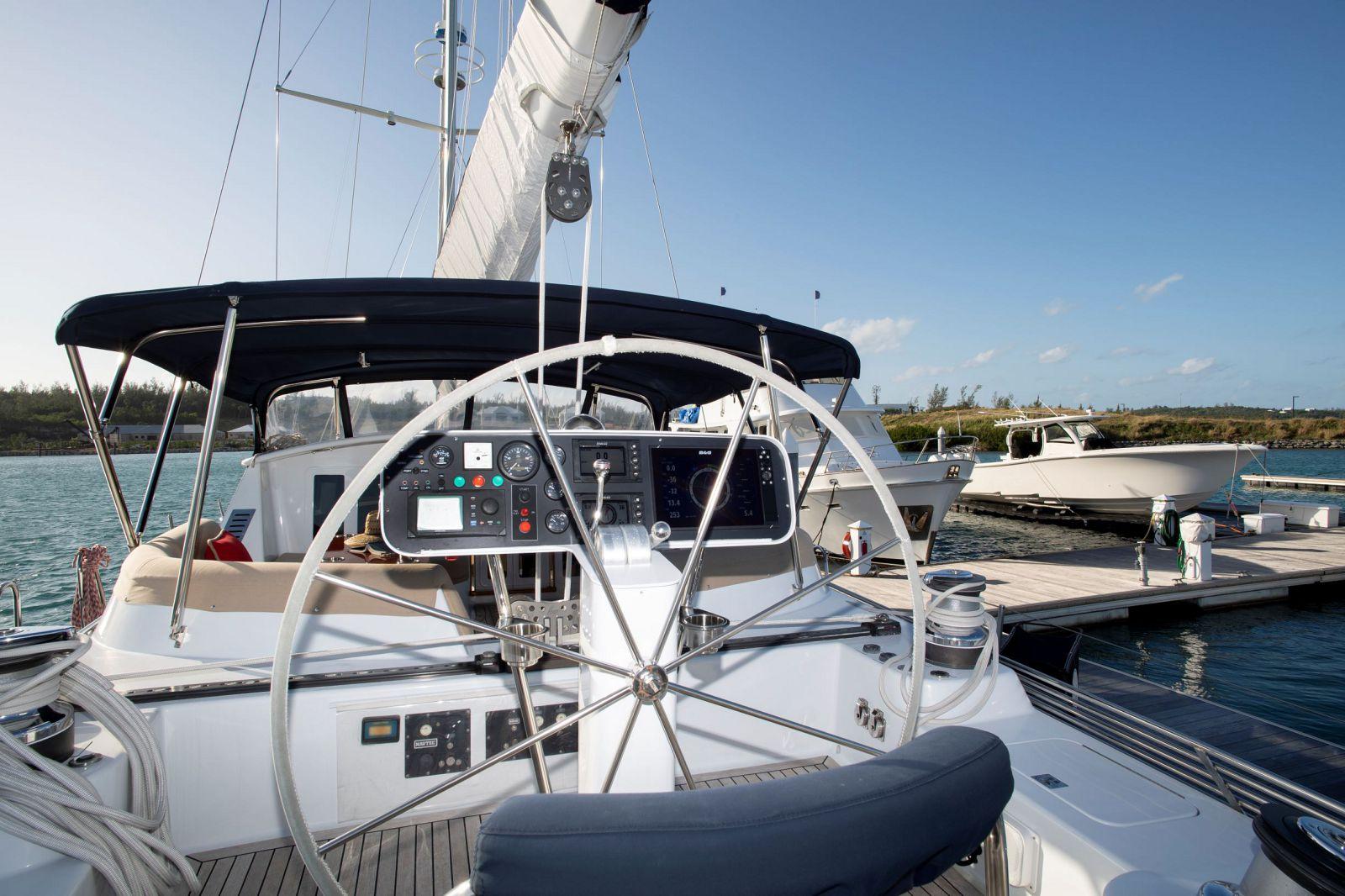 Sailboat cockpit view, Able Custom 97', 1993 model, docked at marina under clear blue sky.