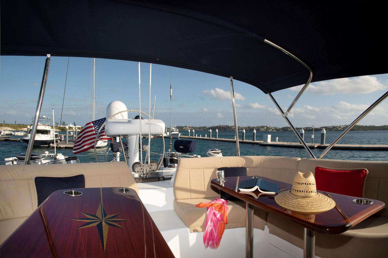 Luxurious Able Custom 97' yacht deck with seating, table, and ocean view, 1993 model.