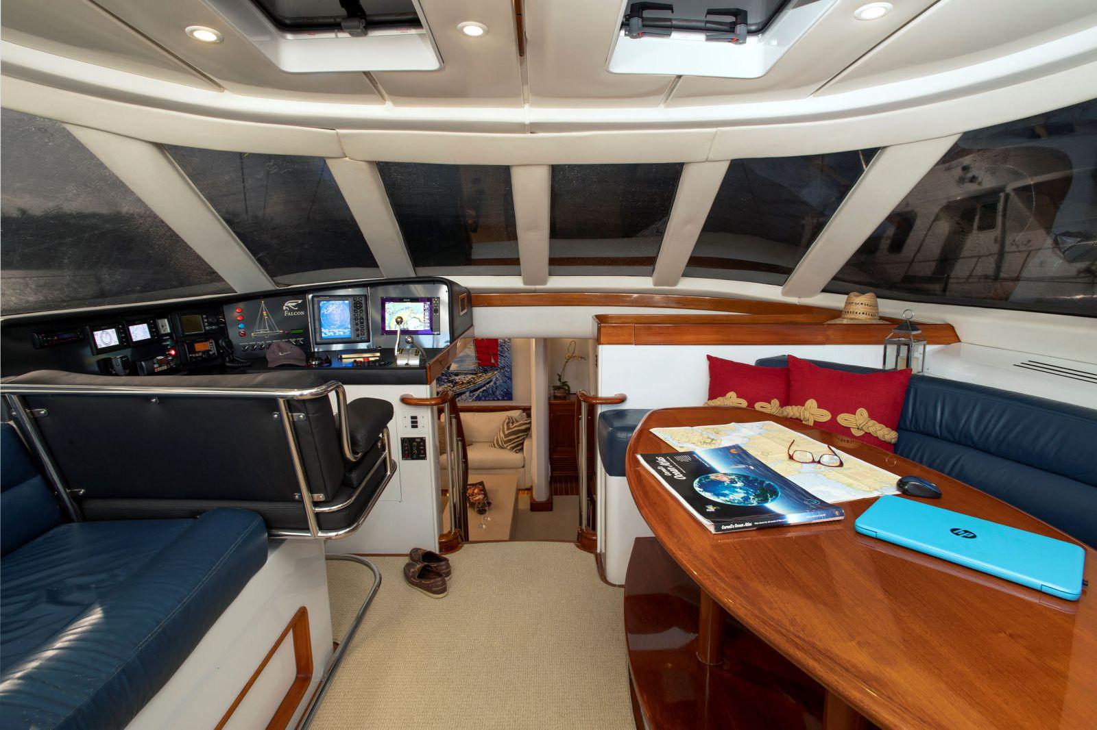 Interior of 1993 Able Custom 97' yacht with navigation station and seating area.