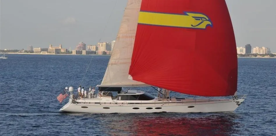 Sailing yacht "Able Custom 97'" 1993 with red sail on open water.