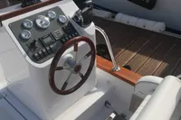 Steering console of 2023 Gozzo Positano 27 Open boat with wooden accents.