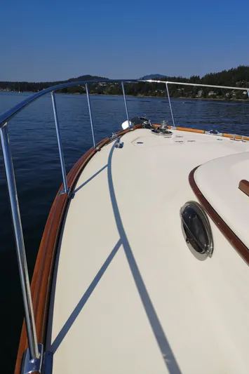 Ripplecove Yacht Photos Pics 2006 Vicem 54 Classic yacht deck with railing, cruising on calm waters under clear blue sky.