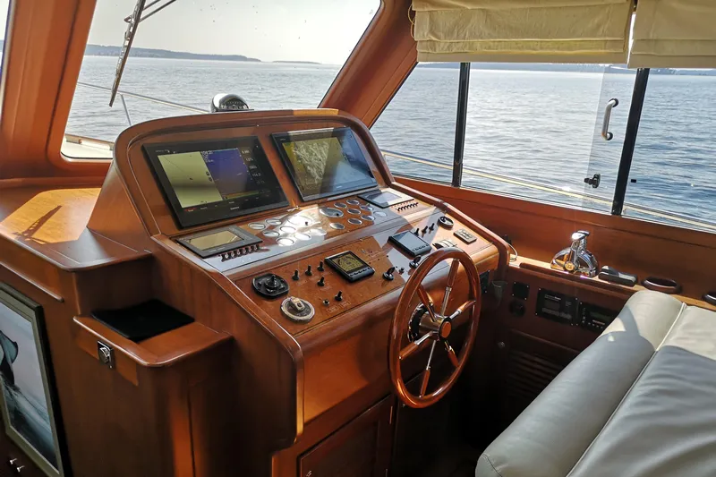 Ripplecove Yacht Photos Pics Helm of 2006 Vicem 54 Classic yacht with navigation equipment and wooden steering wheel.