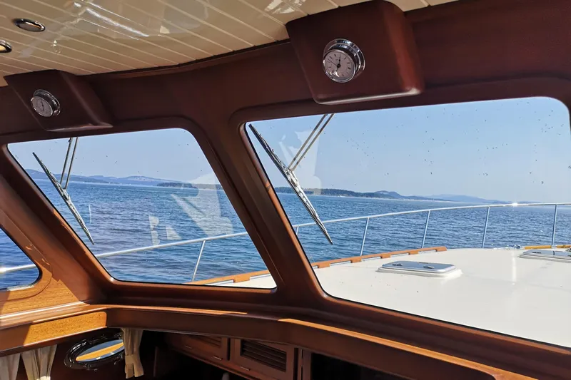 Ripplecove Yacht Photos Pics Interior view from a 2006 Vicem 54 Classic yacht, overlooking the ocean through large windows.