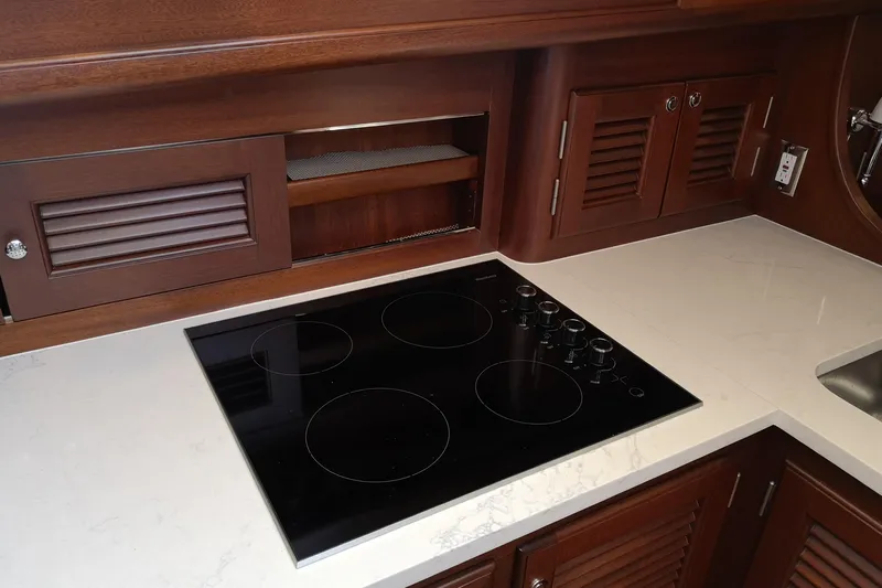 Ripplecove Yacht Photos Pics Luxurious Vicem 54 Classic 2006 yacht kitchen with sleek stovetop and elegant wood cabinetry.