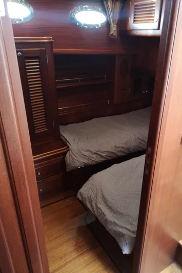 Ripplecove Yacht Photos Pics 2006 Vicem 54 Classic cabin with twin beds, wooden interior, and porthole windows.