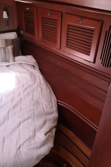 Ripplecove Yacht Photos Pics Vicem 54 Classic 2006 yacht interior with wooden cabinets and cozy bedding.