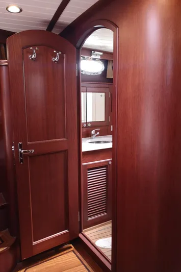 Ripplecove Yacht Photos Pics 2006 Vicem 54 Classic yacht interior with wooden bathroom door and sink.