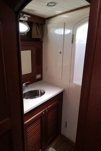 Ripplecove Yacht Photos Pics 2006 Vicem 54 Classic yacht bathroom with wooden cabinetry and stainless steel sink.