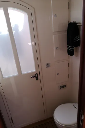 Ripplecove Yacht Photos Pics Bathroom interior of 2006 Vicem 54 Classic yacht, featuring a toilet and towel rack.