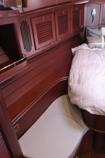 Ripplecove Yacht Photos Pics Luxurious wooden interior of 2006 Vicem 54 Classic yacht cabin with bed and storage.