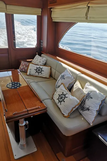 Ripplecove Yacht Photos Pics Luxurious interior of 2006 Vicem 54 Classic yacht with nautical-themed cushions and wooden accents.