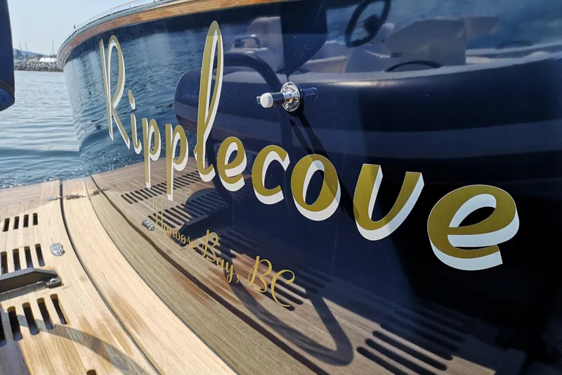 Ripplecove Yacht Photos Pics 2006 Vicem 54 Classic yacht with "Ripplecove" name on the hull, docked in calm waters.