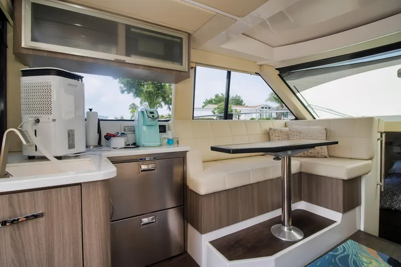  Yacht Photos Pics 2020 Regal 38 XO yacht interior with kitchenette and seating area.