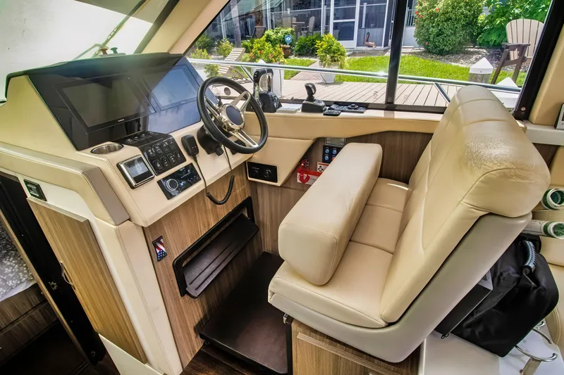  Yacht Photos Pics 2020 Regal 38 XO yacht helm with modern controls and leather seating.