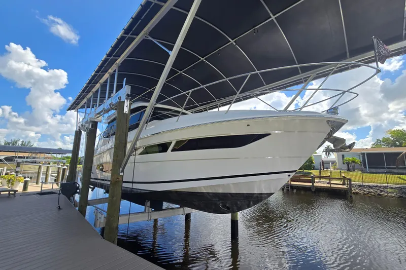  Yacht Photos Pics 2020 Regal 38 XO yacht docked under canopy on a sunny day.