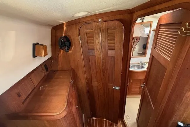 Sugaree Yacht Photos Pics Interior of 1997 Island Packet 37 sailboat with wooden cabinetry and bathroom view.