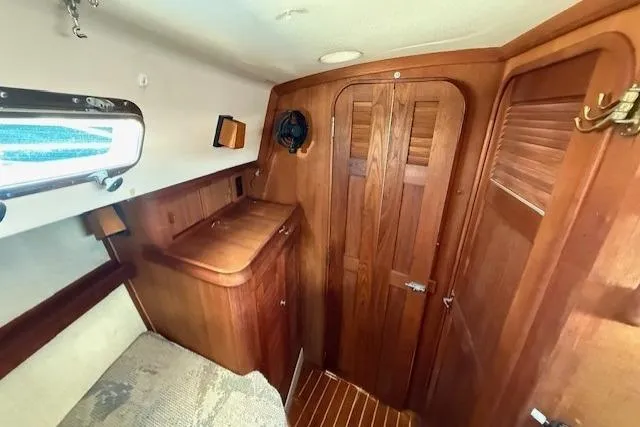 Sugaree Yacht Photos Pics 1997 Island Packet 37 sailboat interior with wooden cabinetry and cozy sleeping area.