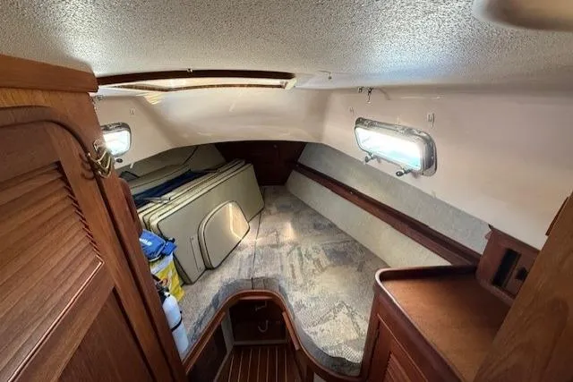 Sugaree Yacht Photos Pics Interior cabin of 1997 Island Packet 37 sailboat with wooden accents and storage space.