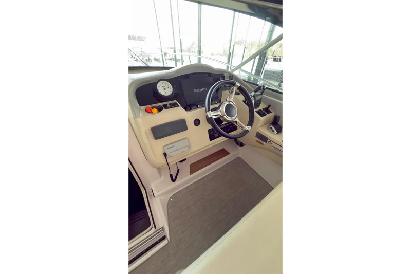  Yacht Photos Pics 2020 Regal 33 Express boat helm with steering wheel and Garmin navigation system.