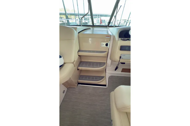  Yacht Photos Pics Interior view of 2020 Regal 33 Express boat, featuring beige seating and steps.