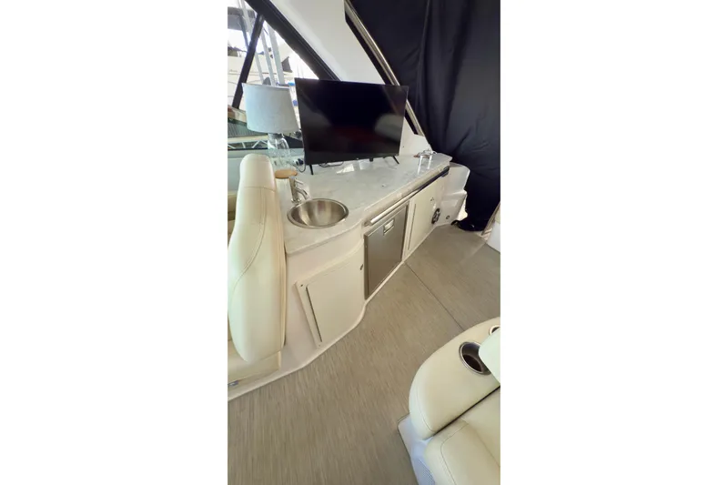  Yacht Photos Pics 2020 Regal 33 Express yacht interior with TV, sink, and seating area.