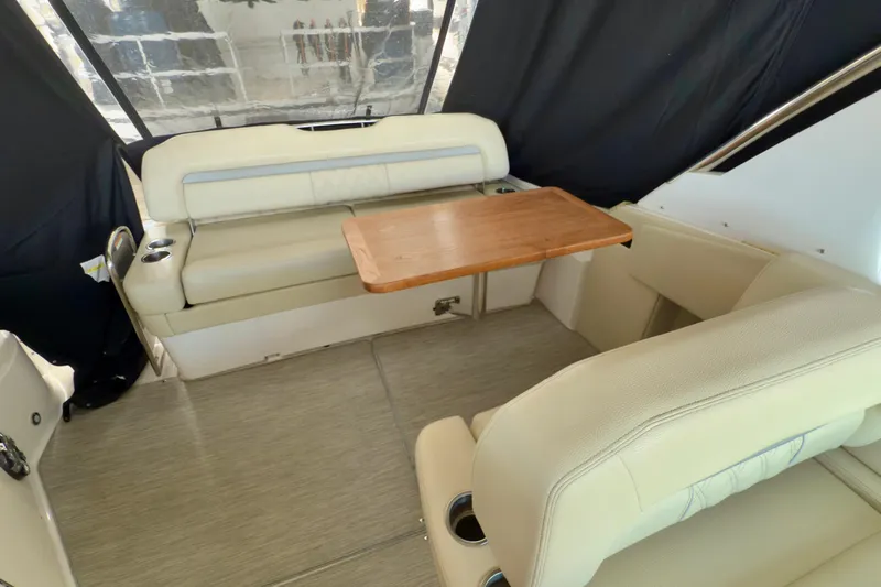  Yacht Photos Pics 2020 Regal 33 Express boat interior with beige seating and wooden table.