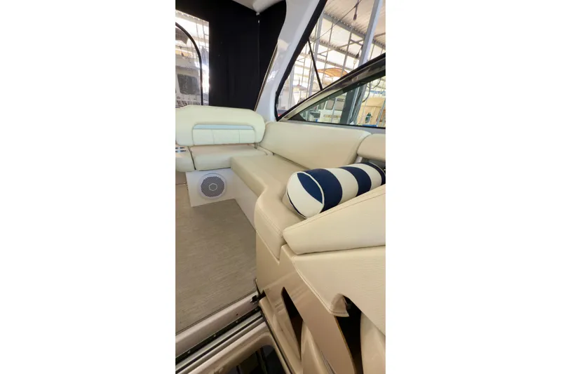  Yacht Photos Pics 2020 Regal 33 Express boat interior with beige seating and striped cushion.