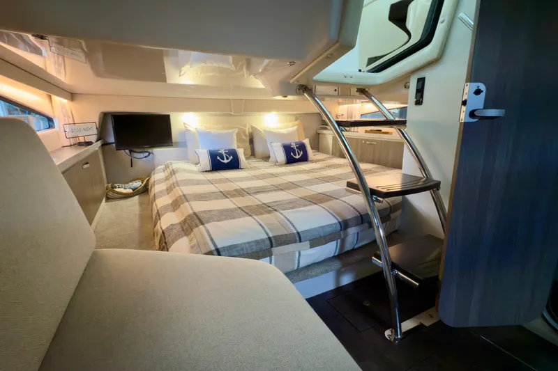  Yacht Photos Pics Luxurious interior of 2020 Regal 33 Express yacht with cozy bed and modern amenities.