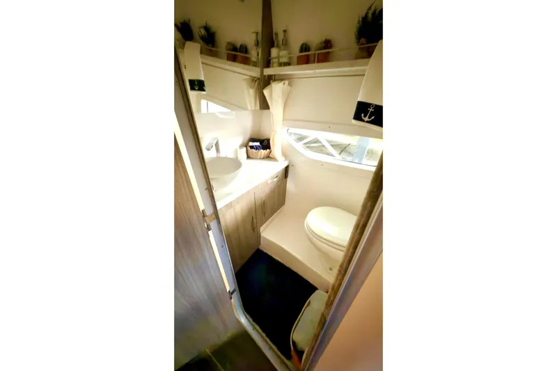  Yacht Photos Pics 2020 Regal 33 Express boat bathroom with modern fixtures and nautical decor.