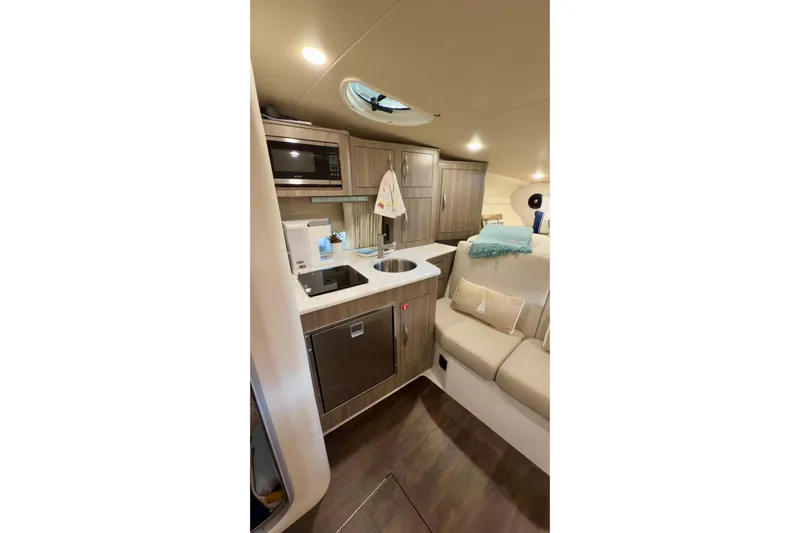  Yacht Photos Pics 2020 Regal 33 Express yacht interior with kitchenette and seating area.