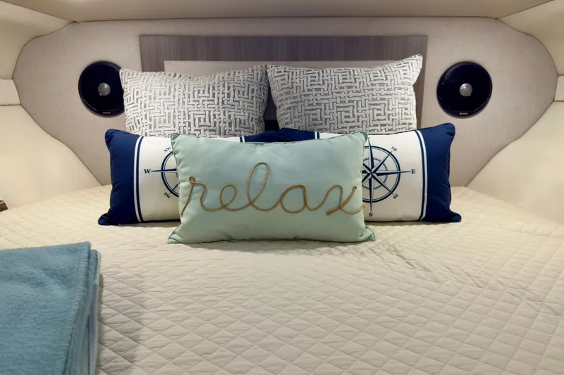 Yacht Photos Pics Cozy cabin interior of 2020 Regal 33 Express with decorative pillows and bedding.