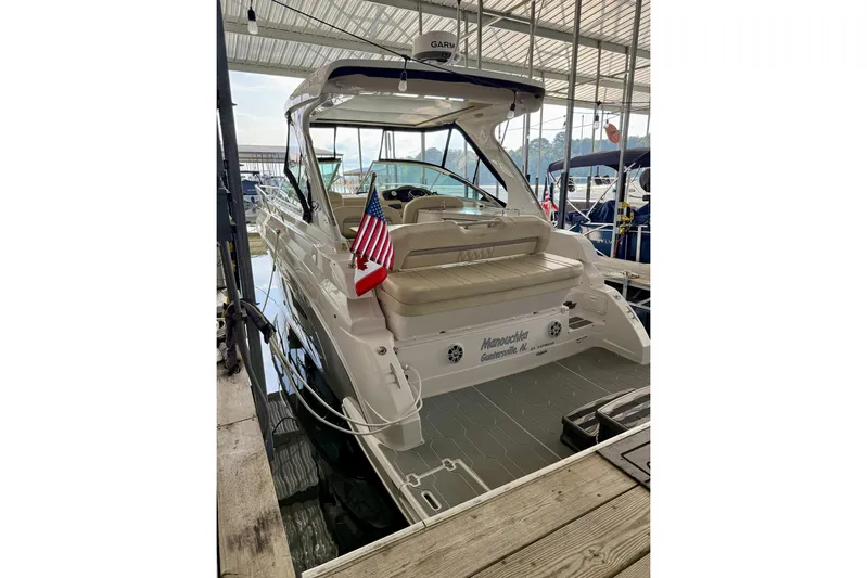  Yacht Photos Pics 2020 Regal 33 Express boat docked, featuring a spacious seating area and American flag.