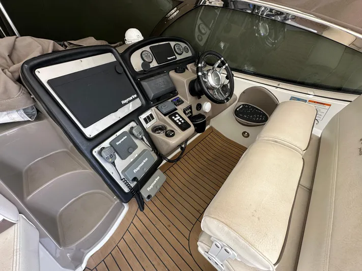 No Dploma Yacht Photos Pics 2009 Cruisers Yachts 420 Express helm with advanced navigation equipment and luxurious seating.