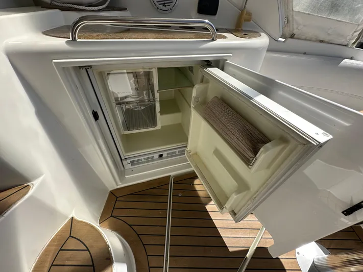 No Dploma Yacht Photos Pics 2009 Cruisers Yachts 420 Express interior with open mini fridge on teak deck.