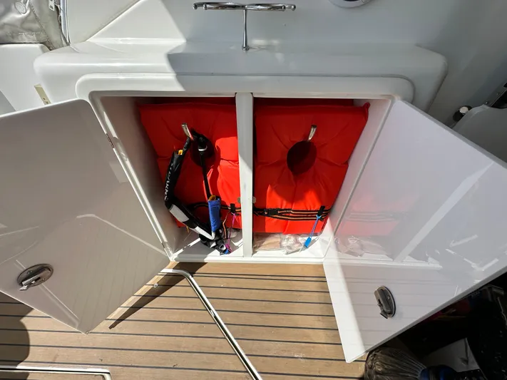 No Dploma Yacht Photos Pics Open storage compartment on 2009 Cruisers Yachts 420 Express with life jackets inside.