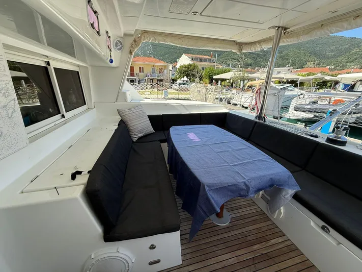  Yacht Photos Pics Lagoon 440 catamaran deck with seating and table, docked at a marina, 2009 model.
