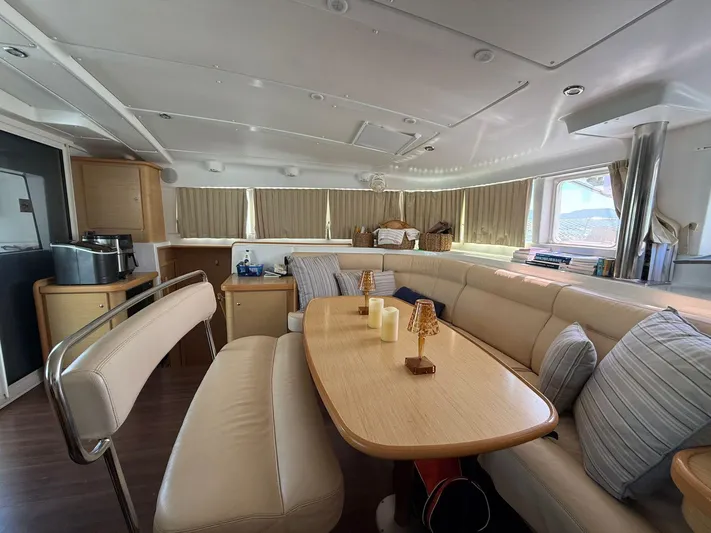  Yacht Photos Pics Luxurious interior of 2009 Lagoon 440 catamaran with elegant seating and dining area.