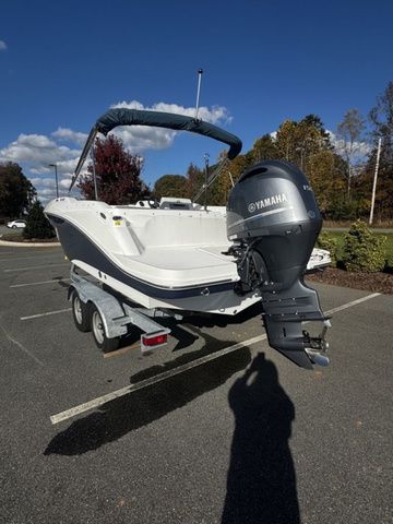 2023 Hurricane SunDeck Sport 205 OB boat with Yamaha outboard motor on a trailer.