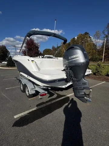 2023 Hurricane SunDeck Sport 205 OB boat with Yamaha outboard motor on a trailer.