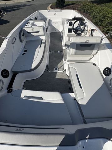 2023 Hurricane SunDeck Sport 205 OB boat interior with seating and steering wheel.