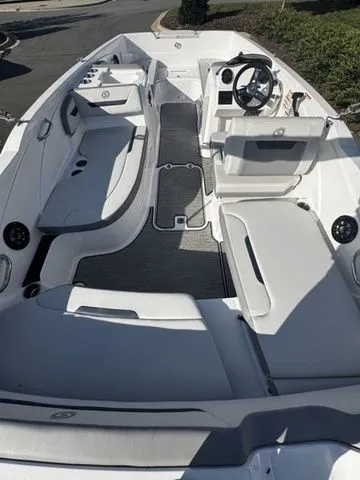 2023 Hurricane SunDeck Sport 205 OB boat interior with seating and steering wheel.