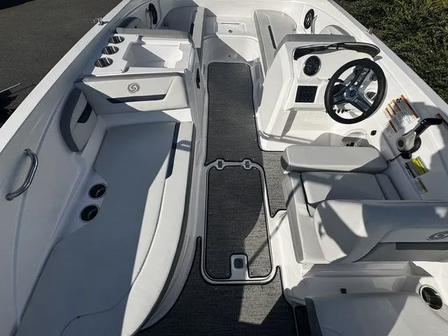 2023 Hurricane SunDeck Sport 205 OB interior with seating, steering wheel, and cup holders.