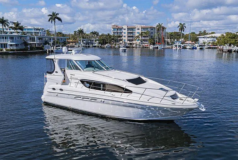 Pure Drive Yacht Photos Pics 2005 Sea Ray 390 Motor Yacht on calm water, with scenic waterfront background.
