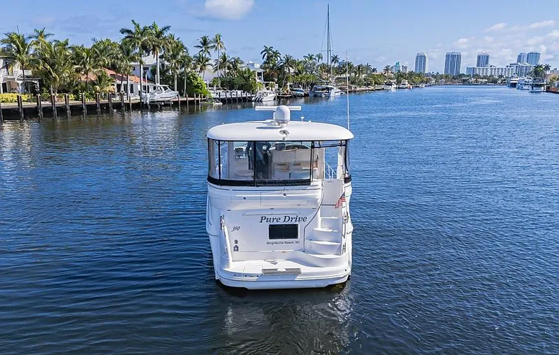 Pure Drive Yacht Photos Pics 2005 Sea Ray 390 Motor Yacht cruising on a scenic waterway.