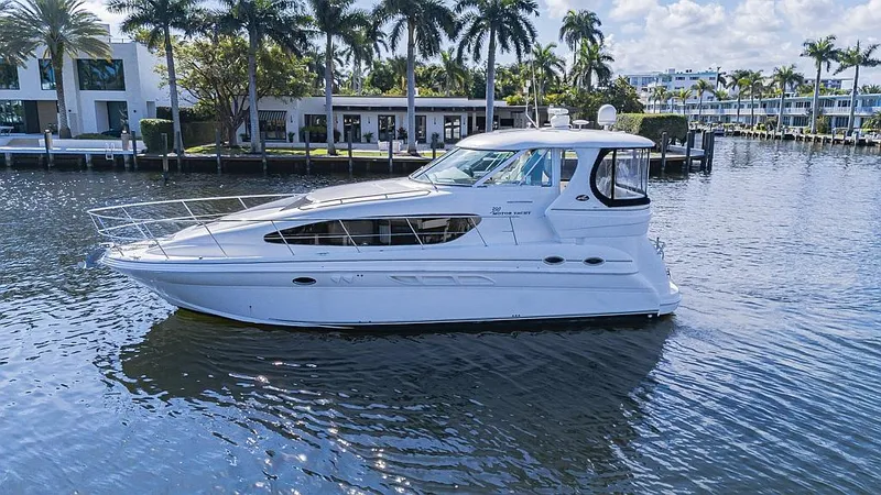 Pure Drive Yacht Photos Pics 2005 Sea Ray 390 Motor Yacht cruising on a scenic waterway with palm trees.