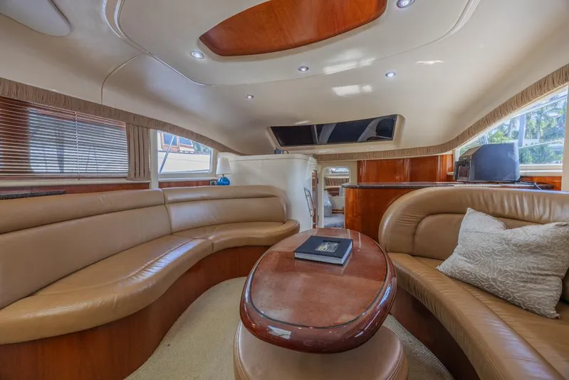 Pure Drive Yacht Photos Pics Luxurious interior of a 2005 Sea Ray 390 Motor Yacht with elegant seating and wooden accents.