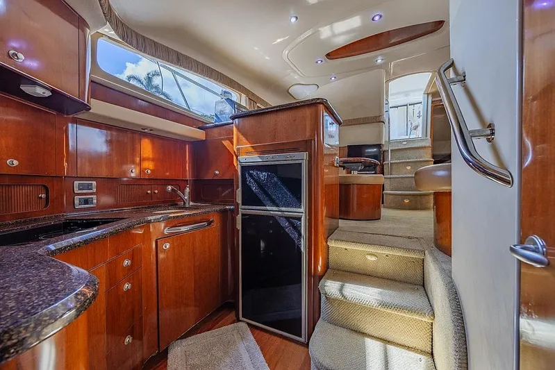 Pure Drive Yacht Photos Pics Luxurious 2005 Sea Ray 390 Motor Yacht interior with elegant wood cabinetry and modern amenities.