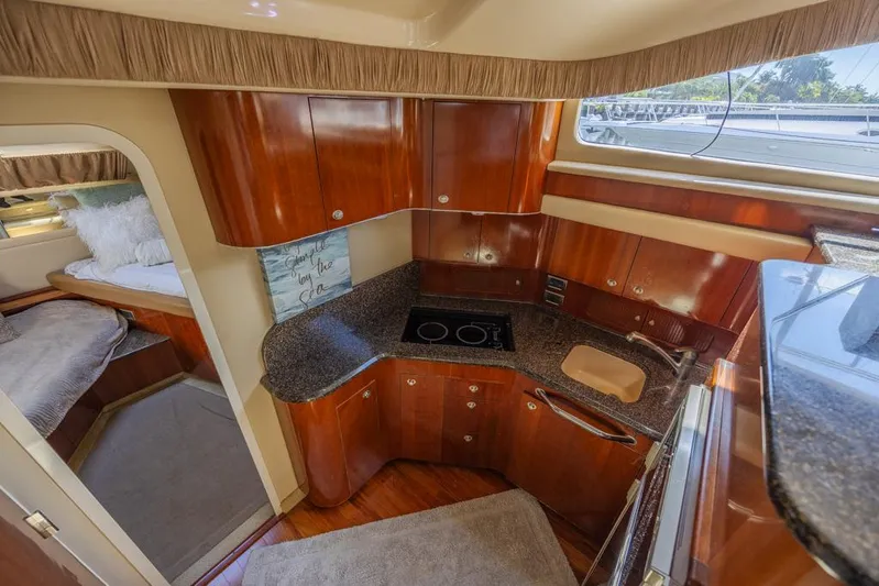 Pure Drive Yacht Photos Pics 2005 Sea Ray 390 Motor Yacht kitchen with wood cabinetry and modern appliances.