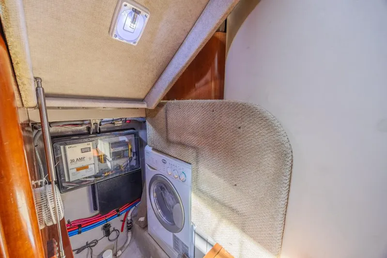 Pure Drive Yacht Photos Pics Laundry area in 2005 Sea Ray 390 Motor Yacht with washer and electrical panel.